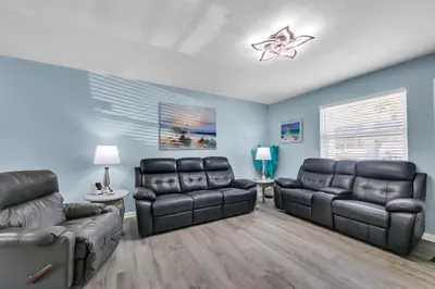 a living room with two leather chairs and a couch at Gulf Highlands 108 in Panama City Beach