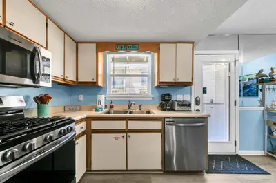 a kitchen with a sink and a stove top oven at Gulf Highlands 108 in Panama City Beach