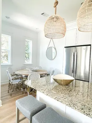 a kitchen with a table and chairs and a refrigerator at Moonlight and Starlight Escape in Panama City Beach