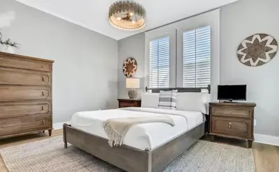a bedroom with a large bed and a dresser at Moonlight and Starlight Escape in Panama City Beach