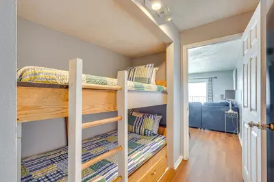 a bedroom with two bunk beds in a room at Steps to Shore PCB Condo with Pool Access and Views! in Panama City Beach