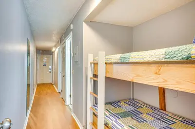 a hallway with two bunk beds in a room at Steps to Shore PCB Condo with Pool Access and Views! in Panama City Beach