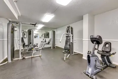 a gym with treadmills and machines in a room at Steps to Shore PCB Condo with Pool Access and Views! in Panama City Beach