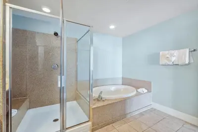 a bathroom with a shower and a sink at Low Floor 3BD plus Bunks Condo! Family Resort! 5 Pools! Free Beach Chair Service! in Panama City Beach