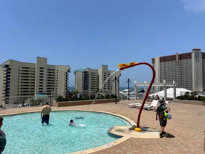 a group of people playing in a swimming pool at Low Floor 3BD plus Bunks Condo! Family Resort! 5 Pools! Free Beach Chair Service! in Panama City Beach