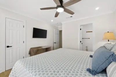 a bedroom with a bed and a ceiling fan at La Costeñita in Panama City Beach