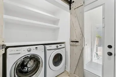 a white laundry room with a washer and dryer at La Costeñita in Panama City Beach