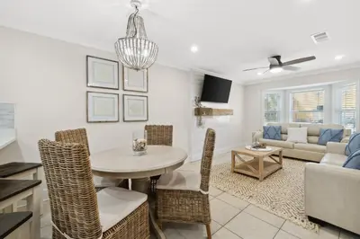 a living room with a table and chairs and a couch at La Costeñita in Panama City Beach