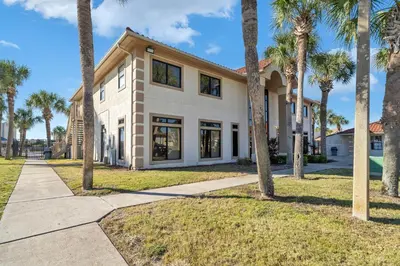 a house with palm trees in front of it at Horizon South 40C- Good Vibes in Panama City Beach