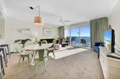 a living room with a table and a living room with a view at Palazzo 404 in Panama City Beach