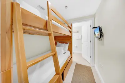 a small room with a bunk bed and a bathroom at Palazzo 404 in Panama City Beach