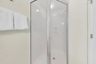 a shower with a glass door in a bathroom at Palazzo 404 in Panama City Beach