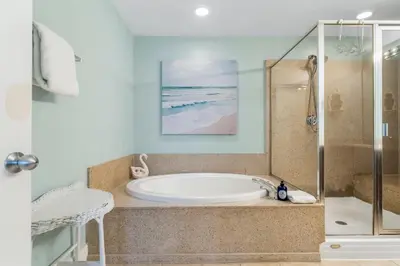 a bathroom with a tub and a shower at Laketown Wharf #721 by Nautical Properties in Panama City Beach