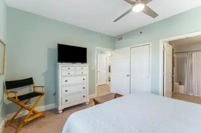 a bedroom with a bed and a flat screen tv at Laketown Wharf #721 by Nautical Properties in Panama City Beach