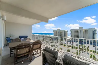 a balcony with a table and chairs and a view of the ocean at Laketown Wharf #721 by Nautical Properties in Panama City Beach