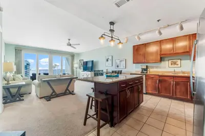 a large kitchen with a table and a couch at Laketown Wharf #721 by Nautical Properties in Panama City Beach