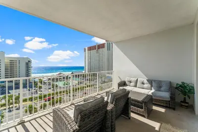 a balcony with a view of the beach and the ocean at Laketown Wharf #721 by Nautical Properties in Panama City Beach