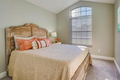 a bedroom with a large bed and a window at Family-Friendly PCB Vacation Rental, Walk to Beach in Panama City Beach