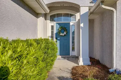 a blue door of a house with a wreath on it at Family-Friendly PCB Vacation Rental, Walk to Beach in Panama City Beach