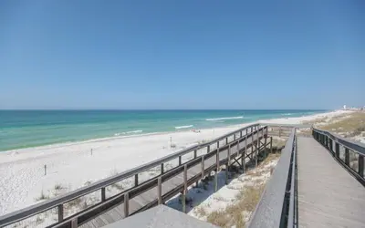 a boardwalk leading to a beach with the ocean at Prominence on 30A Homes by Panhandle Getaways in Watersound Beach