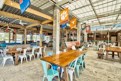 an empty restaurant with wooden tables and chairs at Prominence on 30A Homes by Panhandle Getaways in Watersound Beach