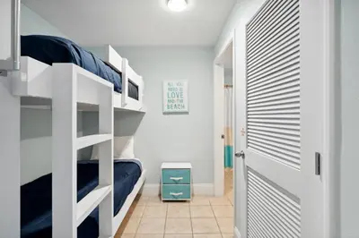 a bedroom with bunk beds and a doorway at Laketown Wharf #302 by Nautical Properties in Panama City Beach