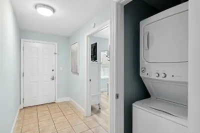 a laundry room with a washer and dryer at Laketown Wharf #302 by Nautical Properties in Panama City Beach