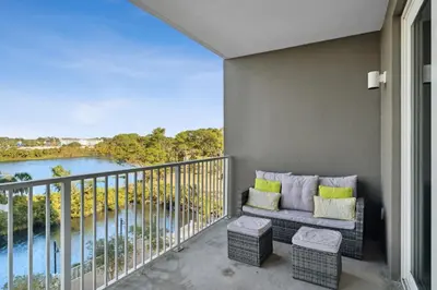 a balcony with a couch and a view of a river at Laketown Wharf #302 by Nautical Properties in Panama City Beach