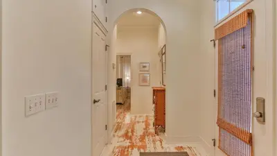 a hallway with an archway in a home with white walls at Conch Cottage - Lovely 2BR in Seagrove Beach in Santa Rosa Beach