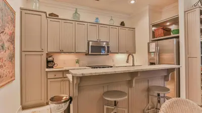 a kitchen with a counter with a microwave and a refrigerator at Conch Cottage - Lovely 2BR in Seagrove Beach in Santa Rosa Beach