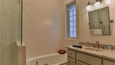a bathroom with a tub and a sink and a shower at Conch Cottage - Lovely 2BR in Seagrove Beach in Santa Rosa Beach