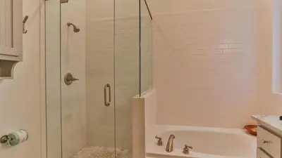 a shower with a glass door in a bathroom at Conch Cottage - Lovely 2BR in Seagrove Beach in Santa Rosa Beach