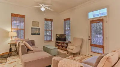 a living room with a couch and chairs and a tv at Conch Cottage - Lovely 2BR in Seagrove Beach in Santa Rosa Beach