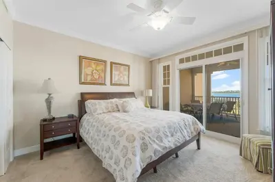 a bedroom with a bed and a view of the ocean at Reflections at Bay Point Unit 412 (3/3) in Panama City Beach