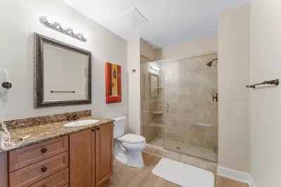 a bathroom with a shower and a toilet and a sink at Reflections at Bay Point Unit 412 (3/3) in Panama City Beach