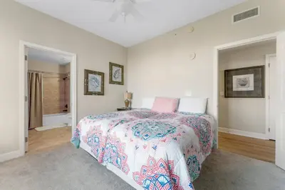 a bedroom with a bed with a colorful bedspread at Reflections at Bay Point Unit 412 (3/3) in Panama City Beach