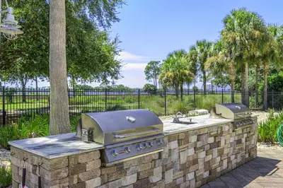 a stone wall with a grill in a park at Reflections at Bay Point Unit 412 (3/3) in Panama City Beach