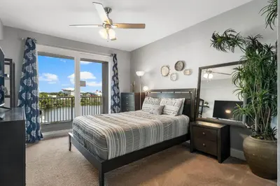 a bedroom with a bed and a large window at Laketown Wharf #311 by Nautical Properties in Panama City Beach