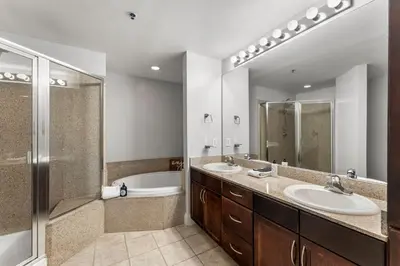 a bathroom with two sinks and a shower and a tub at Laketown Wharf #311 by Nautical Properties in Panama City Beach