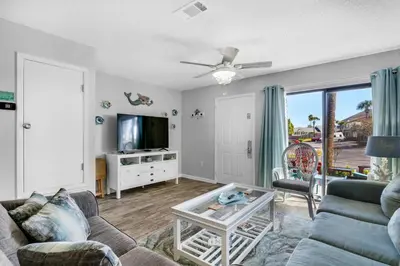 a living room with a couch and a tv at Portside I5 in Panama City Beach