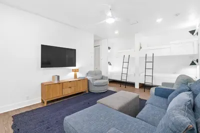 a living room with a blue couch and a tv at Family Tides Beach House by Panhandle Getaways in Panama City Beach