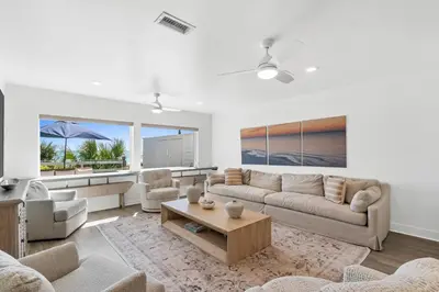 a living room with a couch and a table at Family Tides Beach House by Panhandle Getaways in Panama City Beach