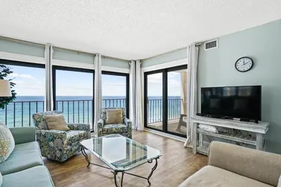 a living room with a television and a couch and chairs at Moondrifter Beach Resort by Panhandle Getaways in Panama City Beach