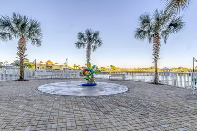 a fountain in a park with palm trees at Laketown Wharf 1226 -2BD+Bunks, Amazing Gulf Views in Panama City Beach