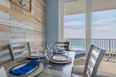 a dining room with a table with a view of the ocean at Laketown Wharf 1226 -2BD+Bunks, Amazing Gulf Views in Panama City Beach