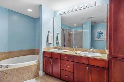 a bathroom with two sinks and a tub and a large mirror at Laketown Wharf 1226 -2BD+Bunks, Amazing Gulf Views in Panama City Beach