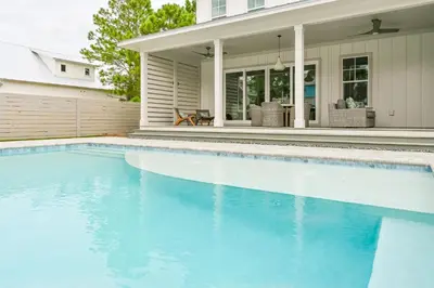 a swimming pool in front of a house at 30 A-mazing in Santa Rosa Beach