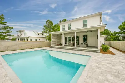 a swimming pool in front of a house at 30 A-mazing in Santa Rosa Beach