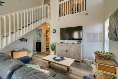 a living room with a couch and a table at Walk to Ocean Condo with Pool and Hot Tub in PCB! in Panama City Beach