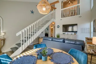 a living room with a table and chairs and a couch at Walk to Ocean Condo with Pool and Hot Tub in PCB! in Panama City Beach